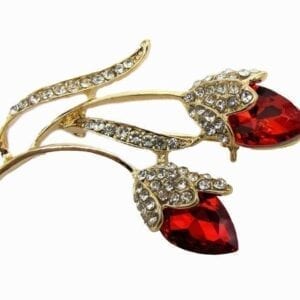 jewelry with deep red gem in a flower design
