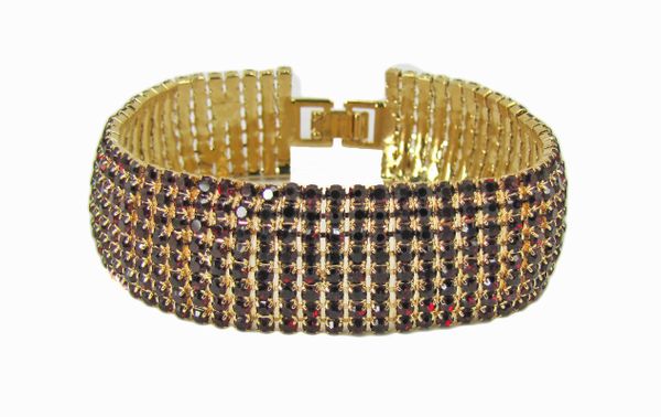 golden bangle with rows of dark gemstones