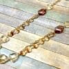 necklace with orange beadwork on wooden surface