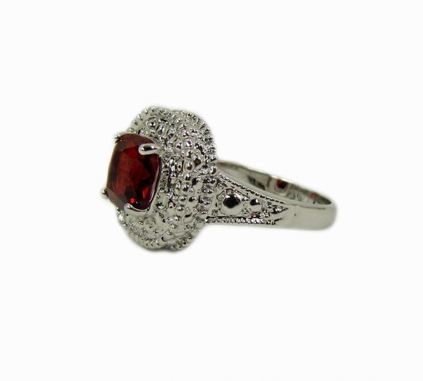 silver ring with red gem inset