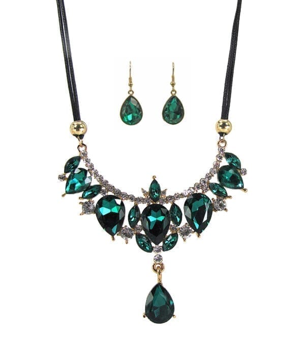 necklace and earrings with emerald gems in an elaborate design