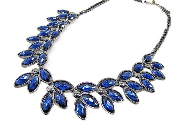 silver necklace with blue crystals in a leaf design