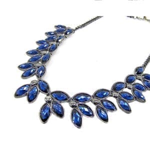 silver necklace with blue gems in a leaf design