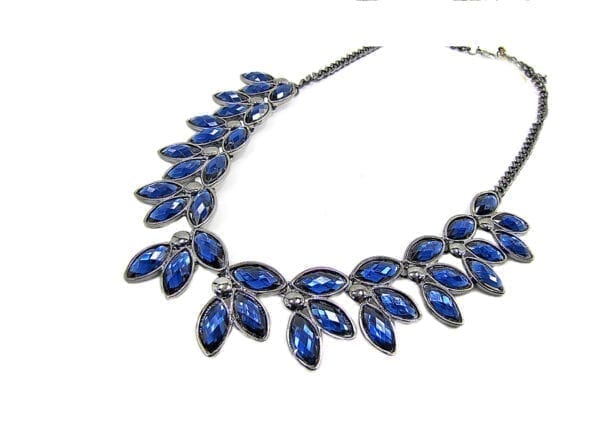 silver necklace with blue gems in a leaf design