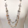 necklace with various designs on a mannequin