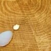 golden necklace with large white stone pendant on a wooden surface