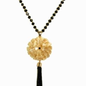 necklace with light yellow floral pendant and tassel