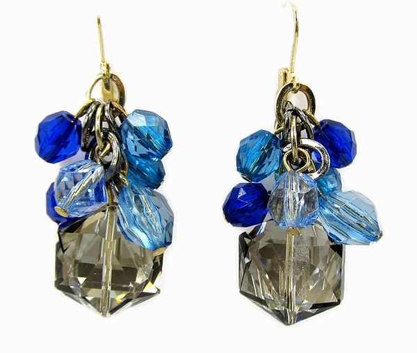 earring with clusters of blue and smoky gems