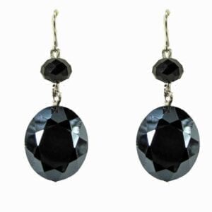 earring with large, black, circular gems