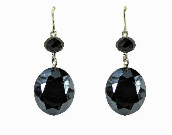 earring with large, black, circular gems