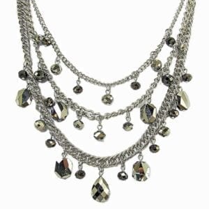 layered silver necklace with dark green crystals