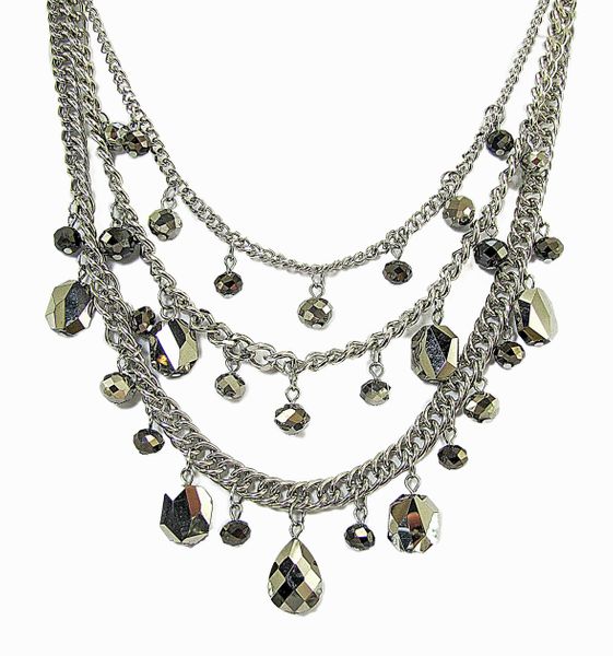 layered silver necklace with dark green crystals