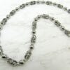 necklace with pearls and silver beads on marble surface