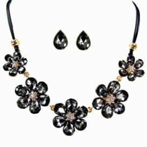 necklace and earrings with dark crystals arranged in flowers