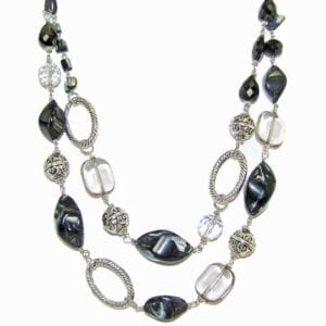 layered necklace with silver beads and dark gems