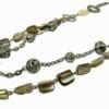 close up of a layered necklace with metal balls and banded beads