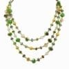 layered necklace with green and yellow gems