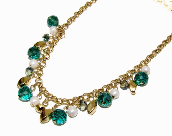 gold necklace with blue gem and golden pebble attachments