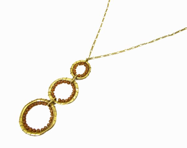 necklace pendant with a column of three golden hoops