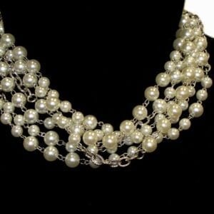 pearl necklace with silver chains on a mannequin
