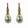 side view of earrings with teardrop pearl hanging on a golden hook