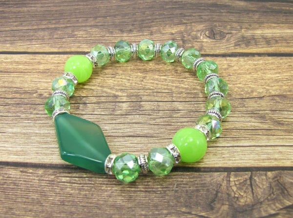 bracelet with jade beads and large jade pendant on a wooden surface