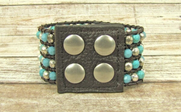 view of a black bracelet with silver and sky blue beads