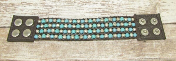 black bracelet with silver and sky blue beads laid horizontally