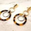 earrings with circular metal rings interlocking on a marble surface