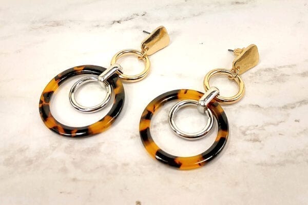 earrings with circular metal rings interlocking on a marble surface