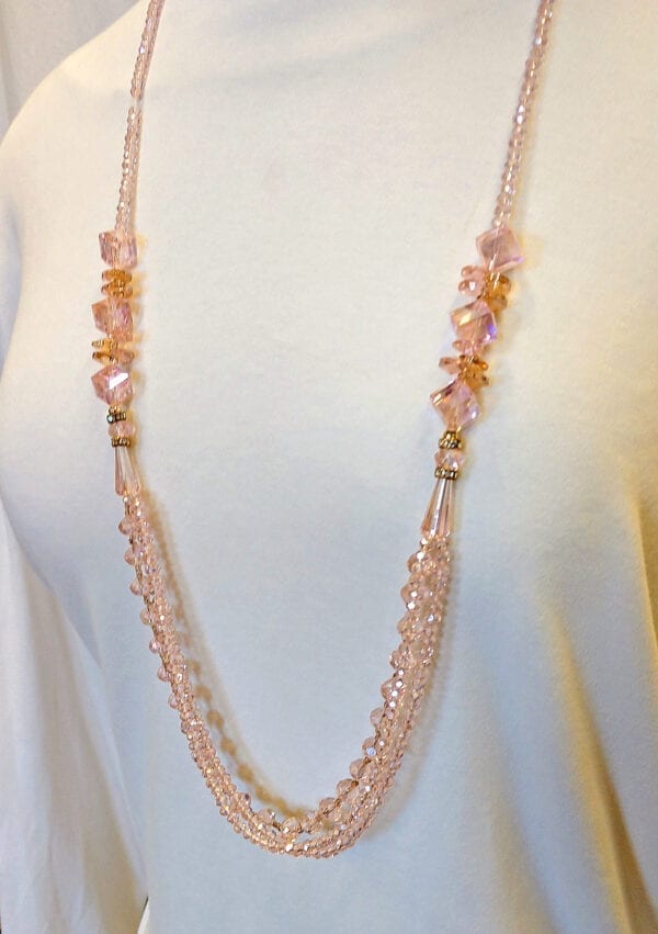 layered necklace with pink crystals on a mannequin