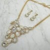 necklace and earrings with pearl and diamond crystals arranged like vines on marble surface