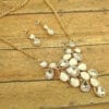 necklace with pearl and diamond crystals arranged like vines on a wooden surface
