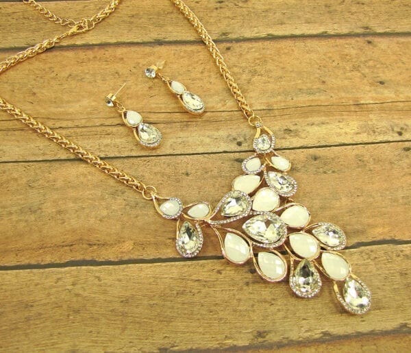 necklace with pearl and diamond crystals arranged like vines on a wooden surface