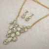 necklace and earrings with pearl and diamond crystals arranged like vines on a pink cloth