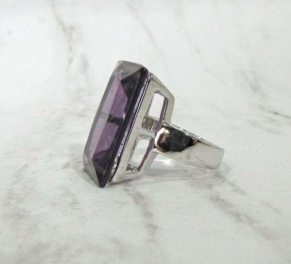side view of a ring with square cut purple gem