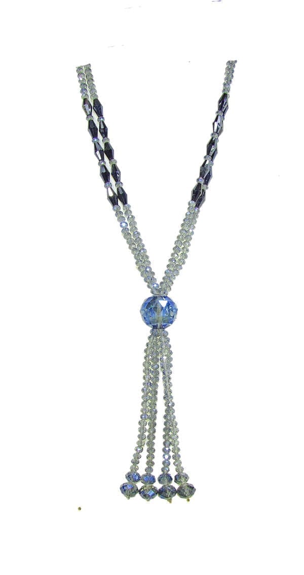 close up of a crystal necklace with large blue crystal pendant