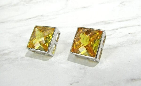 square-cut topaz earrings on marble surface