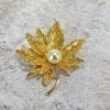 GOLDEN TEXTURED LEAF PIN WITH PEARL - Image 2