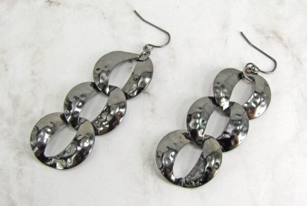 earrings with interconnected silver rings on marble surface