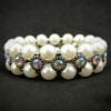 pearl bracelet with rainbow-colored gems on black velvet