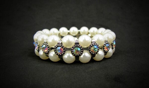 pearl bracelet with rainbow-colored gems on black velvet