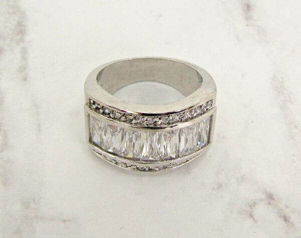 ring with rows of white rectangular crystals on marble surface
