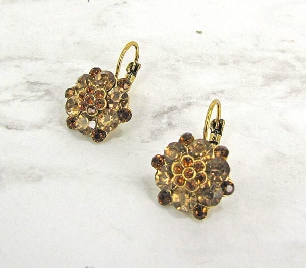 earrings with brown gems arranged like flowers on a marble surface