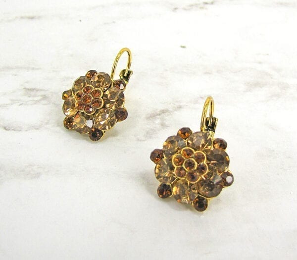 earrings with brown gemstones arranged like flowers on a marble surface