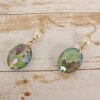 earrings with blue crystal and pearl on a wooden surface