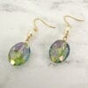 earrings with blue crystal and pearl on a marble surface