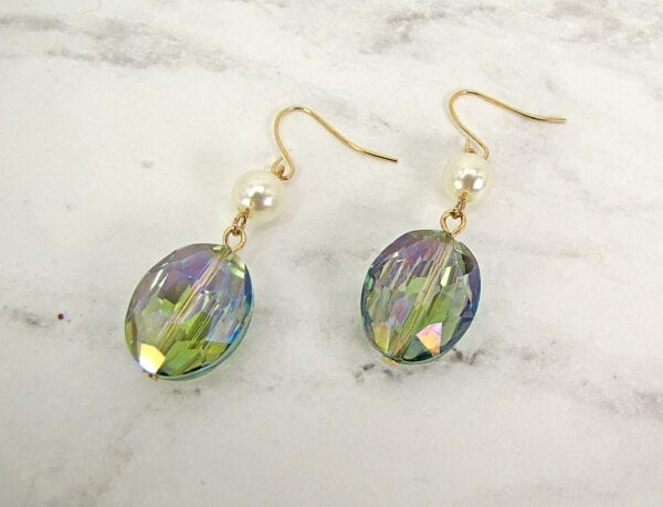 earrings with blue crystal and pearl on a marble surface