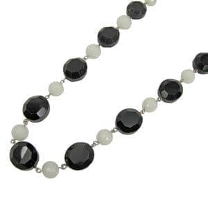 segment of a necklace with white and black gemstones