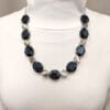 necklace with black crystals and metallic beads on a mannequin
